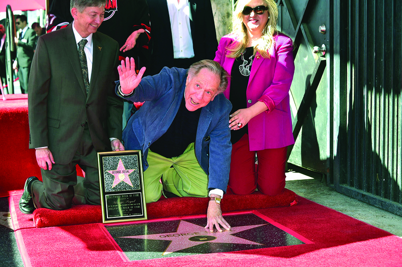 In this file photo actor George Segal puts his hand on his star during his Walk of Fame ceremony in Hollywood, California.-AFP n