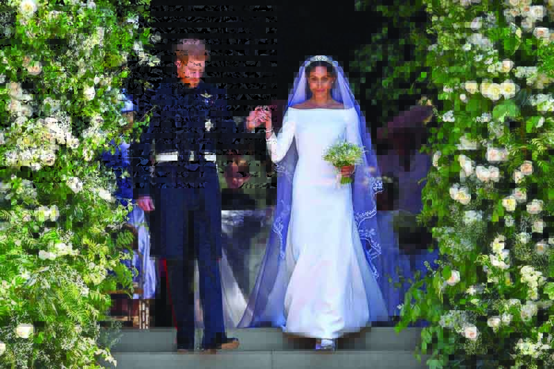 In this file photo Britain's Prince Harry, Duke of Sussex and his wife Meghan, Duchess of Sussex walk down the west steps of St George's Chapel, Windsor Castle, in Windsor, after their wedding ceremony.-AFP n