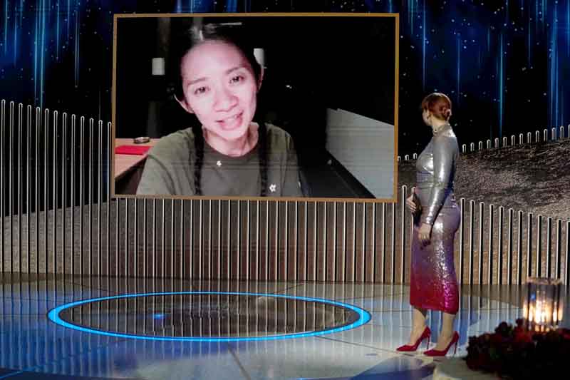 This handout photo shows Chloe Zhao (on screen) accepting the Best Director - Motion Picture award for “Nomadland” via video from Bryce Dallas Howard onstage at the 78th Annual Golden Globe Awards held at the Rainbow Room.—AFP n