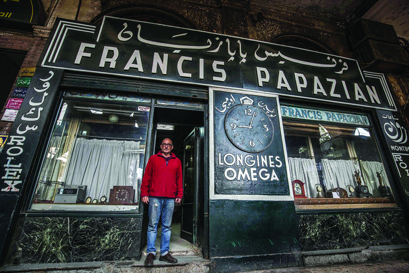Ashod Papazian, a 64-year-old Armenian Egyptian watchmaker, poses for a photo outside his family-owned business - the Francis Papazian watchmaker's shop - in Attaba district, Cairo.n