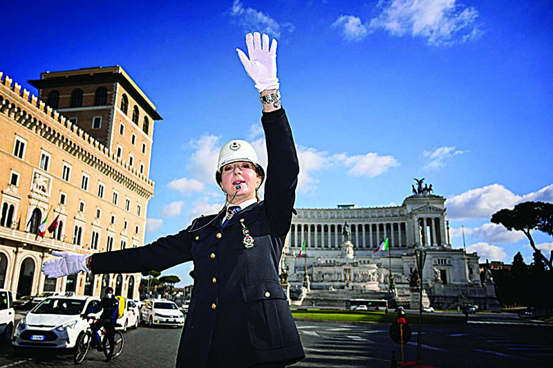 Female municipal police traffic officer, Cristina Corbucci directs traffic on the historic platform on Piazza Venezia in central Rome amid restrictions of the COVID-19 coronavirus pandemic. —AFP