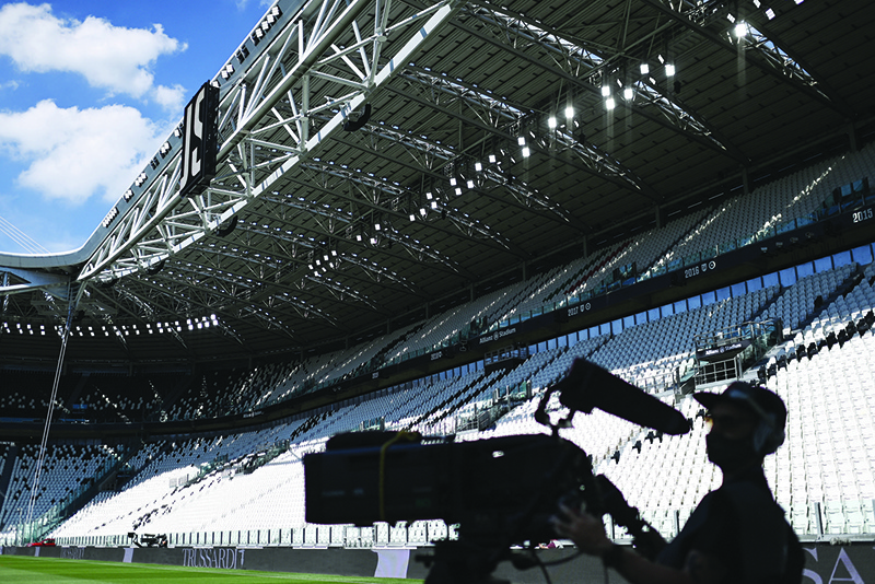 TURIN: In this file photo taken on July 04, 2020 a television cameraman prepares to broadcast the Italian Serie A football match Juventus vs Torino played behind closed doors at the Juventus stadium in Turin. — AFP