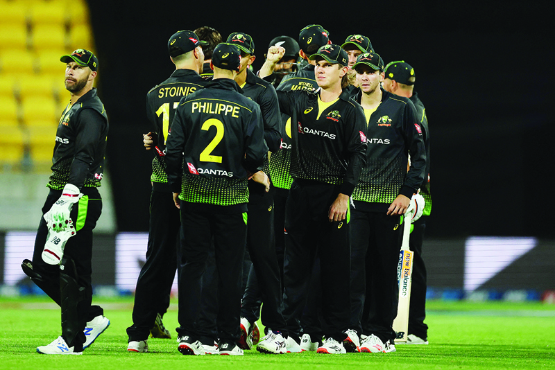 WELLINGTON: Australian players celebrate their win during the third Twenty20 cricket match between New Zealand and Australia in Wellington yesterday. - AFPn