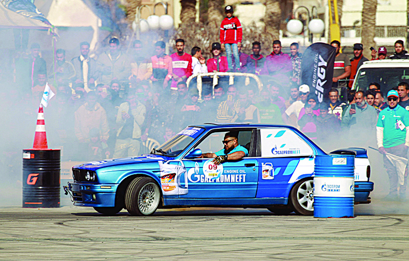 BENGHAZI: Libyans watch a driver put his drifting skills to the test during a competition in the coastal city of Benghazi, on March 12, 2021. - AFPn