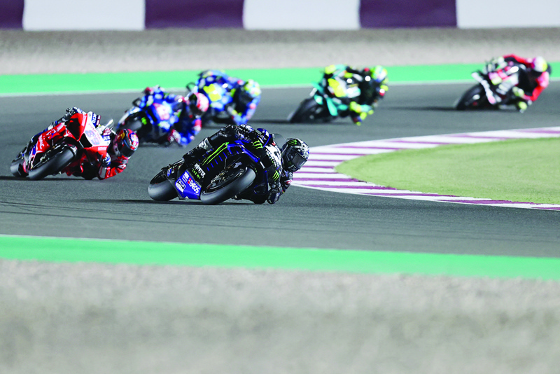 LUSAIL: Monster Energy Yamaha MotoGP's Spanish rider Maverick Vinales (center) drives during the Moto GP Qatar Grand Prix at the Losail International Circuit, in the city of Lusail on Sunday. - AFPnn