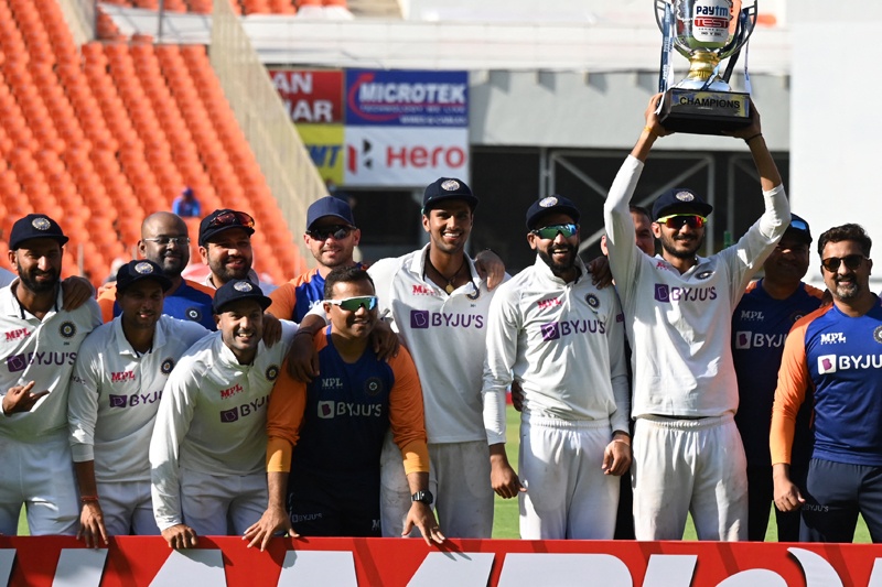 AHMEDABAD: Indian players and team officials pose with the trophy after winning the test series against England at the end of their fourth Test cricket match at the Narendra Modi Stadium in Motera yesterday. - AFPn