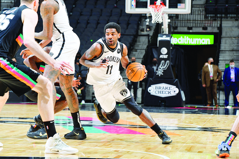 SAN ANTONIO: Kyrie Irving #11 of the Brooklyn Nets drives to the basket against the San Antonio Spurs on Monday at the AT&T Center in San Antonio, Texas. - AFPn