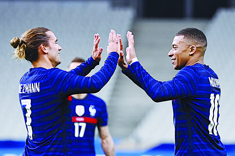SAINT-DENIS: In this file photo taken on October 07, 2020 France's forward Kylian Mbappe (right) is congratulated by France's forward Antoine Griezmann after scoring a goal during the International friendly football match between France and Ukraine in Saint-Denis, outside Paris. - AFPn