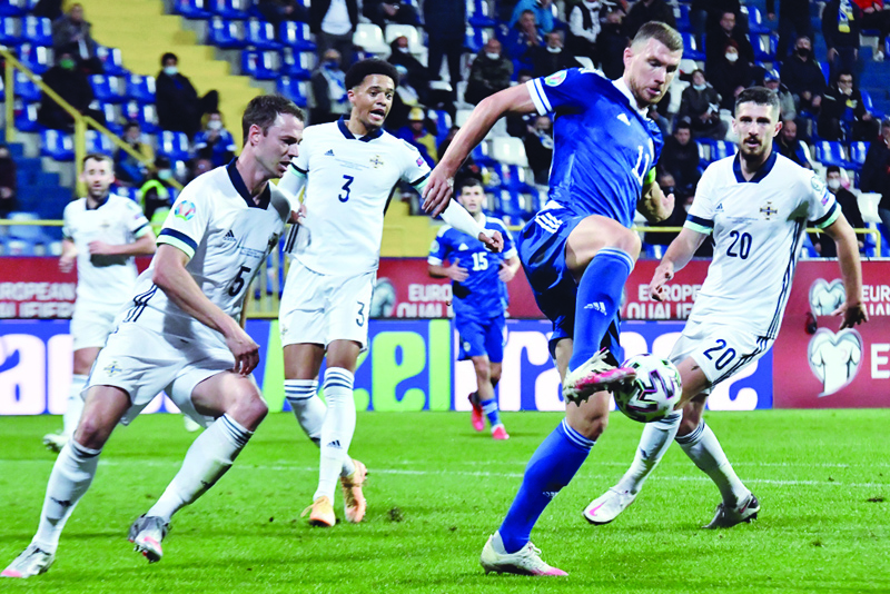 SARAJEVO: In this file photo taken on October 8, 2020 Bosnia and Herzegovina's forward Edin Dzeko (2R) controls the ball next to Northern Ireland's defenders during the UEFA Euro 2020 Play-off Semi-Final football match between Bosnia and Herzegovina and Northern Ireland in Sarajevo. - AFPn
