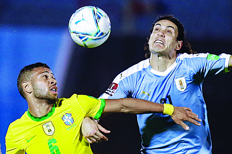 MONTEVIDEO: In this file photo taken on November 17, 2020 Brazil's Renan Lodi (left) and Uruguay's Edinson Cavani vie for the ball during their closed-door 2022 FIFA World Cup South American qualifier football match at the Centenario Stadium in Montevideo. - AFPn