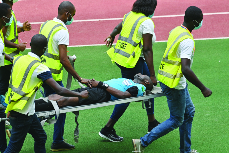 ANYAMA: Rescuers carry Ghanaian referee Charles Bemle Bulu after a discomfort during the 2021 Africa Cup of Nations qualifying football match between Ivory Coast and Ethiopa at the Alassane Ouattara Stadium in Anyama on Tuesday. - AFP n