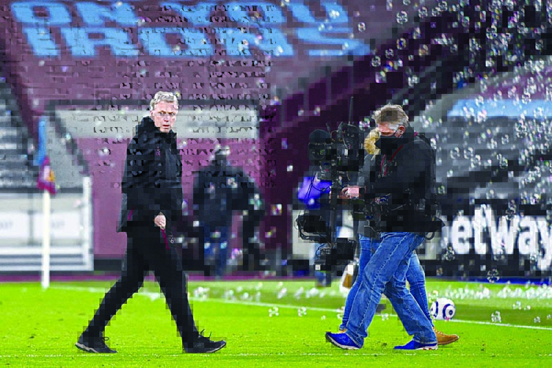 LONDON: The television camera follows West Ham United's Scottish manager David Moyes as he leaves after the English Premier League football match between West Ham United and Leeds United at The London Stadium, in east London on March 8, 2021. - AFPn