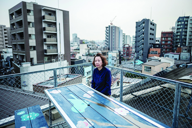 TOKYO: In this picture taken on March 12, 2021 Toshiko Ishii, who runs Andon ryokan, a traditional style Japanese hotel, poses on the rooftop of her hotel in Taito district of Tokyo. - AFPn