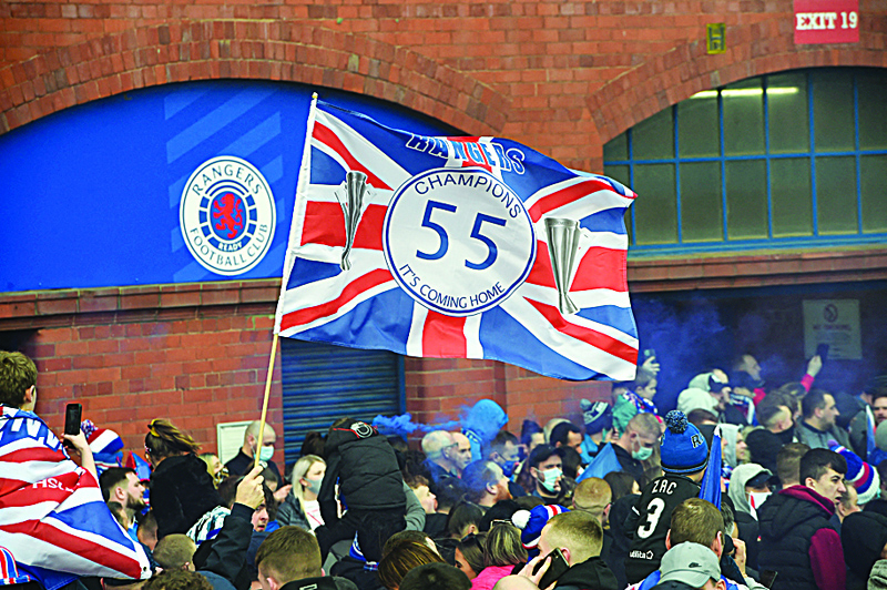 GLASGOW : Rangers fans celebrate outside Ibrox Stadium, home of Rangers Football Club, in Glasgow on Sunday after their first Scottish Premiership title for 10 years was confirmed. - AFPn