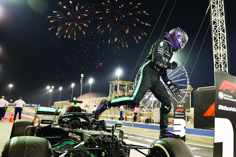 SAKHIR: Mercedes' British driver Lewis Hamilton celebrates after winning the Bahrain Formula One Grand Prix at the Bahrain International Circuit in the city of Sakhir on Sunday. - AFPn