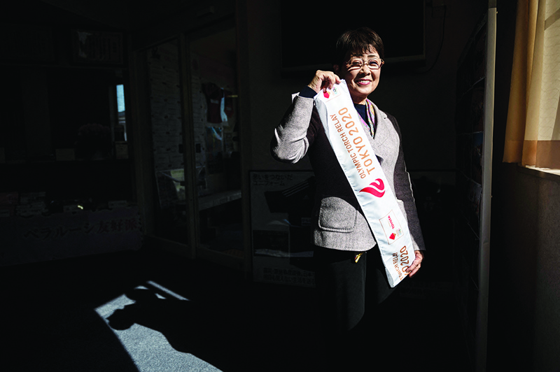 HIRONO: In this picture taken on February 28, 2021, Tokyo 2020 Olympic torch relay runner Yumiko Nishimoto poses for a photo in Hirono, Fukushima Prefecture. - AFPn