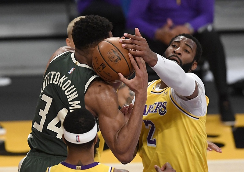 LOS ANGELES: Giannis Antetokounmpo #34 of the Milwaukee Bucks scores a basket against Andre Drummond #2 of the Los Angeles Lakers during the first half of the game at Staples Center on Wednesday. —AFP