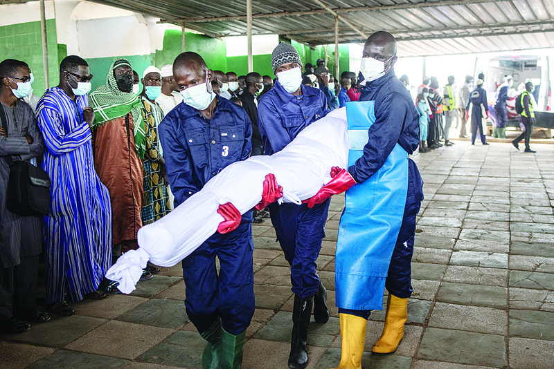 DAKAR: Volunteers of the Association For Solidarity and Perfection carry one of the twenty eight unidentified corpses to a Mosque ahead of a Prayer in Dakar. - AFPn