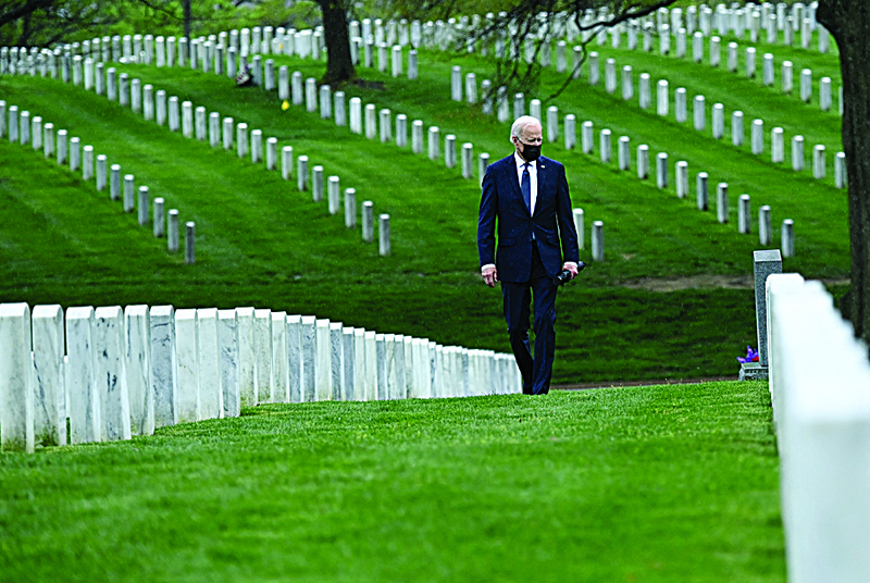 ARLINGTON: US President Joe Biden walks through Arlington National cemetery to honor fallen veterans of the Afghan conflict in Arlington, Virginia on Wednesday. - AFPn