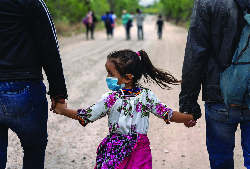 LA JOYA, Texas: An immigrant child glances back towards Mexico after crossing the border into the United States in La Joya, Texas. - AFPn