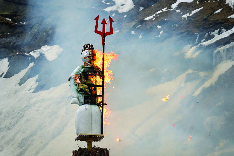 The Boeoegg, a symbolic snowman, is seen burning over the Devil's Bridge during the Sechselaeuten (Ringing of the six o'clock bells) festival near Andermatt, central Switzerland.-AFP photosn