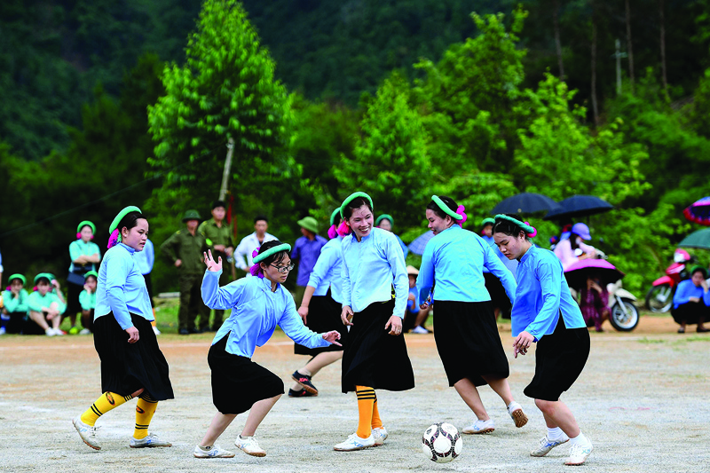 Ethnic San Chi women dressed in traditional costumes play a friendly football match as part of the Soong Co festival celebrations in northern Vietnam's Quang Ninh province.—AFP photosn