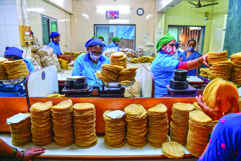 Staff of Shri Mahila Griha Udyog, the organization that produces the famous Lijjat Papad, pack rolled papadums. - AFPnn