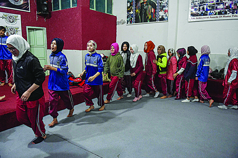 In this picture taken on Jan 31, 2021, female students of the Hazara community warm up before a martial arts training class at the Kazmi International Wushu Academy in Quetta. - AFP photosn