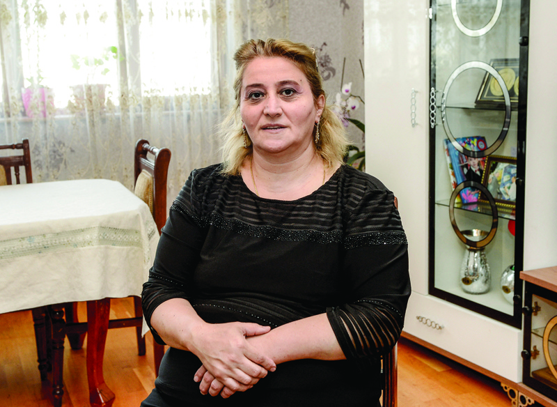 BAKU: Azerbaijani Ramziya Sharifova, 47, poses during an interview with AFP at her apartment in Baku.-AFPn