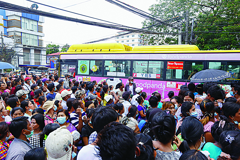 YANGON: Relatives gather around a bus carrying prisoners to be released outside Insein Prison in Yangon yesterday as thousands of inmates were freed nationwide to mark the country’s traditional Buddhist New Year holiday. —AFP