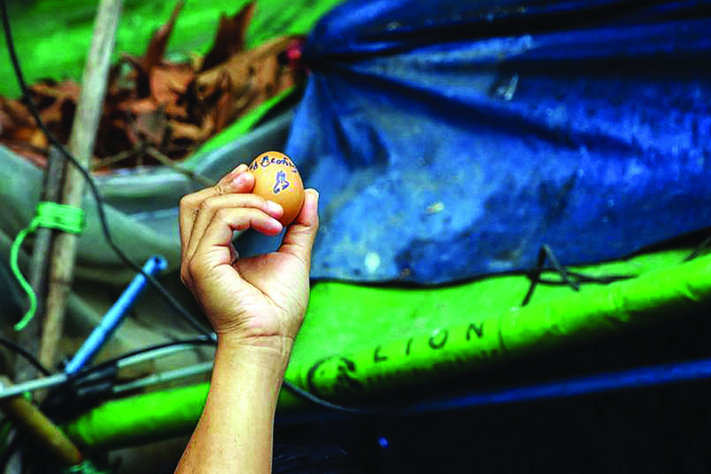 YANGON: This photo taken and received from an anonymous source via Facebook yesterday shows a protester holding an egg, to coincide with Easter Sunday and decorated with a message in support of demonstrations against the military coup, during a demonstration in Yangon's Insein township. -- AFPn
