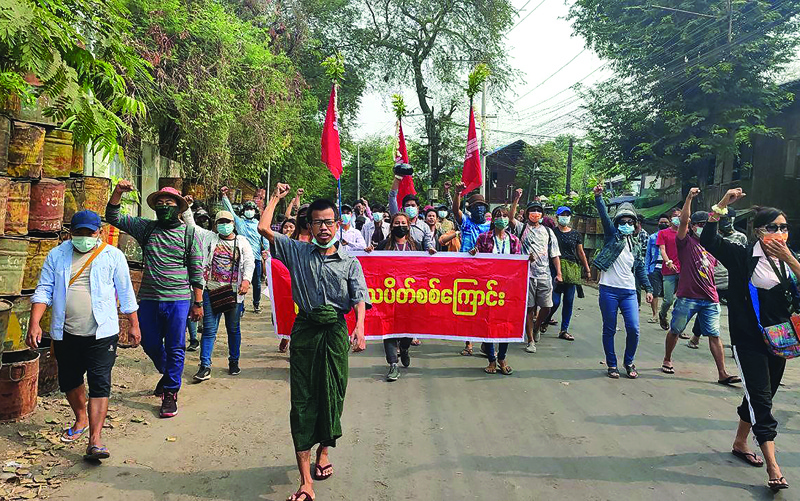 MANDALAY: This photo taken and received from an anonymous source via Facebook yesterday shows protesters holding a banner as they march during a demonstration against the military coup in Mandalay. -- AFPn