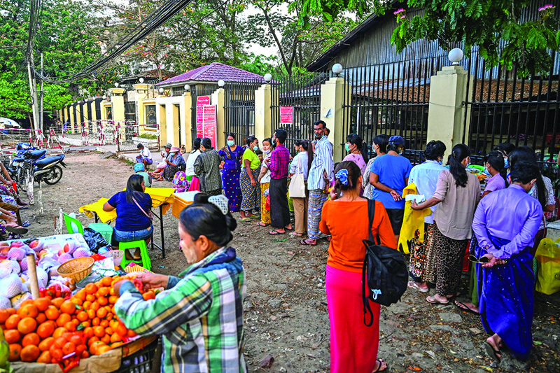 YANGON: People queue in front of Insein prison in Yangon yesterday while they wait to visit inmates ahead of the long holiday stretch for the Myanmar New Year, also known as Thingyan, as the country remains in turmoil after the February military coup. -- AFPn