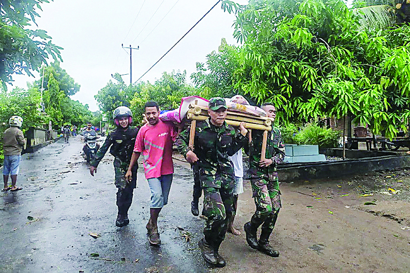 Villagers carry the body of a victim after flash floods in Lembata, East Flores Monday as torrential rains triggered floods and landslides that have killed at least 91 people and left dozens missing in Indonesia and neighboring East Timor. -- AFPn