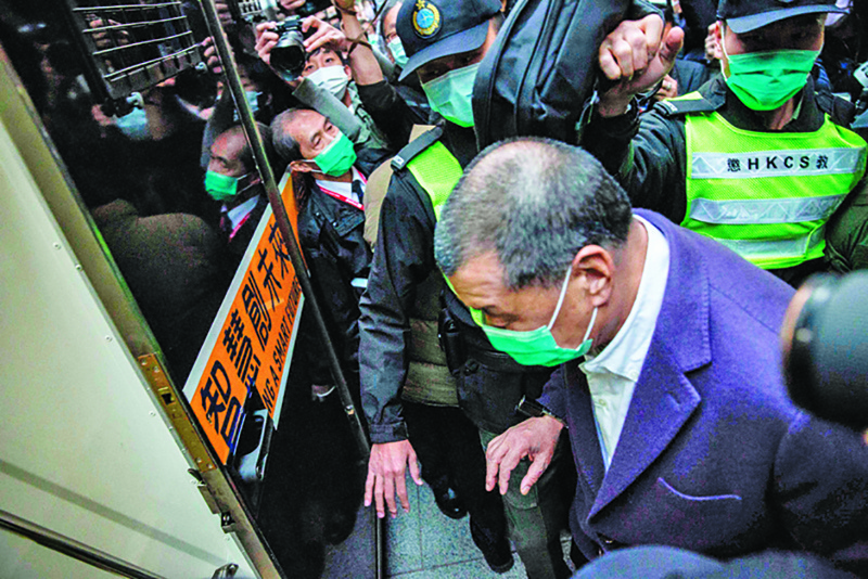 HONG KONG: In this file photo, media tycoon Jimmy Lai is escorted onto a prison van outside the Court of Final Appeal after he was ordered back to jail as the city's highest court granted prosecutors an appeal against his bail. - AFPn