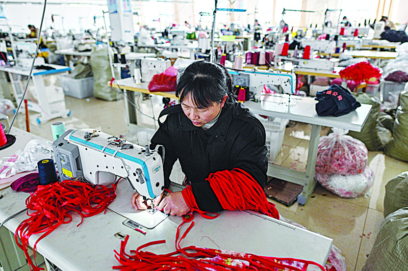 GUANYUN, China: This photo taken on March 25, 2021 shows a worker sewing at a lingerie factory in this county, some 50 km from Lianyungang in China's northeastern Jiangsu province. - AFP n