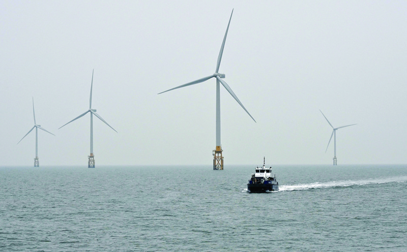 This picture taken on March 4, 2021 shows a service vessel sailing among turbine towers at an offshore wind farm in waters some 10 km off Gochang. - AFPn