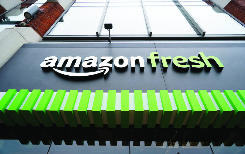 In this file photo taken on March 04, 2021 an 'amazon fresh' logo is pictured above the entrance to Amazon's new Amazon Fresh store in Ealing, west London. A new coalition of small business groups Tuesday launched a campaign for tougher US antitrust enforcement, specifically calling for the breakup of online commerce titan Amazon. - AFPn