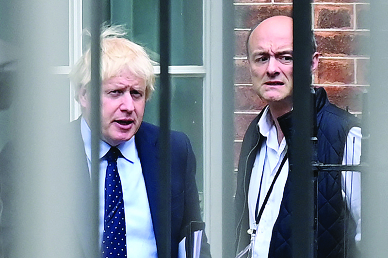 In this file photo, Britain's Prime Minister Boris Johnson (left) and his special advisor Dominic Cummings leave from the rear of Downing Street in central London, before heading to the Houses of Parliament.-AFPn