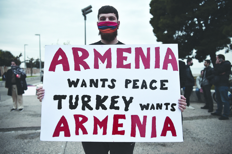 THESSALONIKI, Greece: A member of the Armenian community holds placard during a rally to commemorate the 106th anniversary of the Armenian genocide, in Thessaloniki.-AFPn