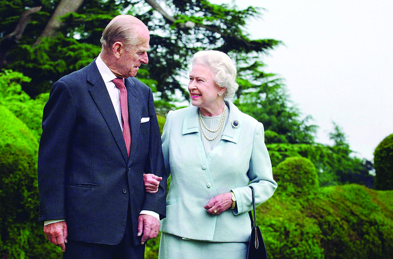 In this file photo taken in 2007 shows Britain's Queen Elizabeth II and her husband, Britain's Prince Philip, Duke of Edinburgh (left) walking at Broadlands, Hampshire, earlier in the year. - AFPn