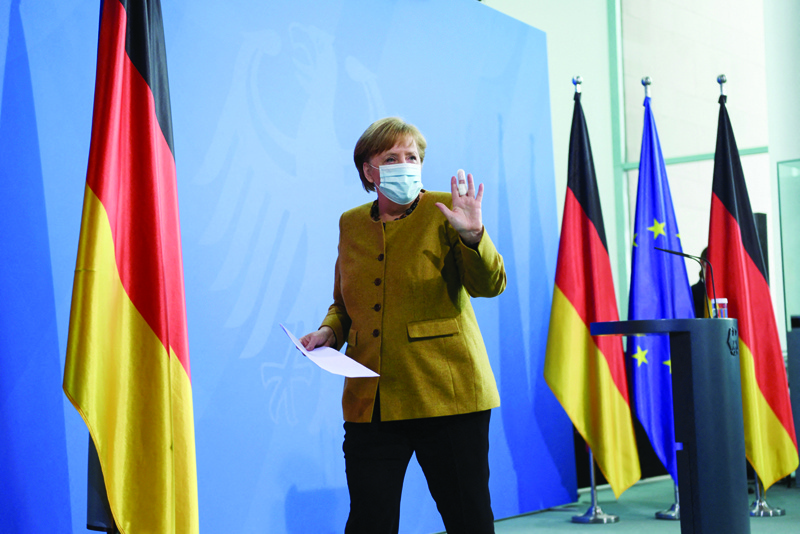 BERLIN: German Chancellor Angela Merkel leaves after giving a statement in Berlin yesterday amid the novel coronavirus COVID-19 pandemic. -- AFPn