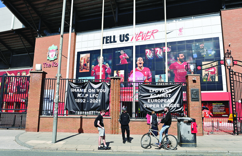 LIVERPOOL: Anti-European Super League posters hang outside Anfield stadium, home of English Premier League football club Liverpool, in Liverpool, north west England yesterday. - AFPn
