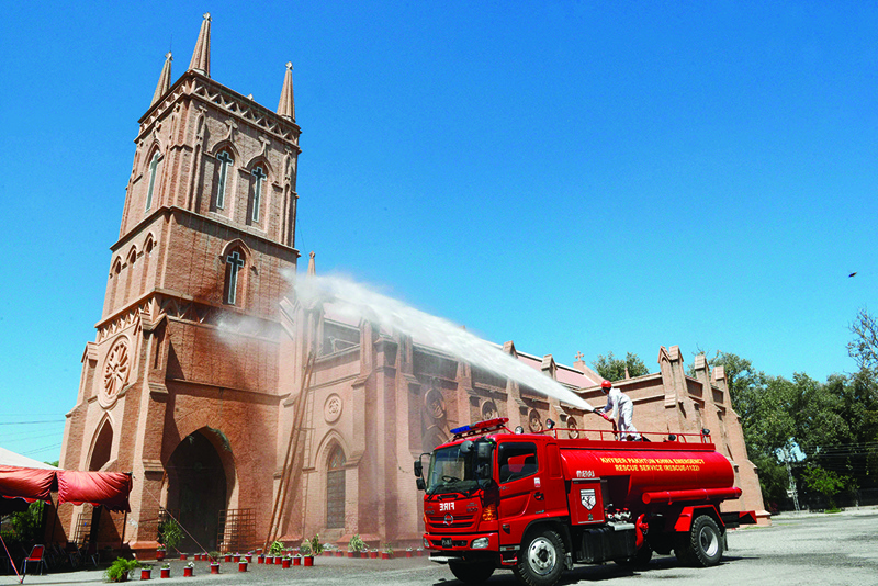 PESHAWAR: A water cannon is used to disinfect St John's Cathedral Church as a preventive measure against COVID-19 on the eve of Easter yesterday. - AFP n