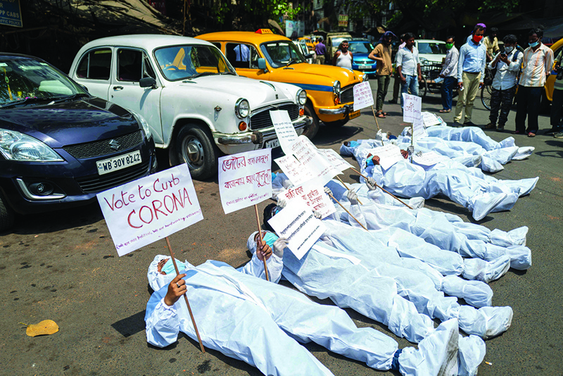 KOLKATA: Protesters display placards near the Election Commission office yesterday demanding the halt of the state legislative election and campaign rallies amidst the rising number of COVID-19 cases. – AFP n