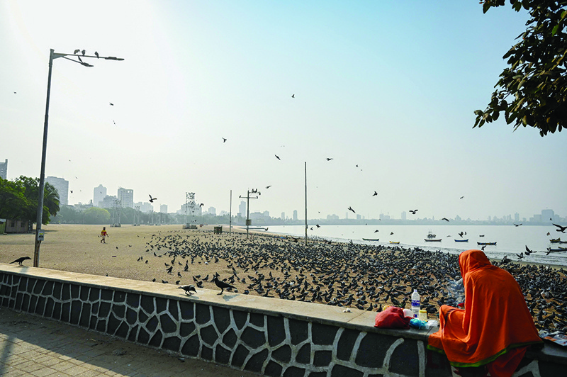 MUMBAI: A Hindu priest is seen near the deserted Chowpatty beach during a weekend lockdown imposed by the state government amidst rising COVID-19 cases yesterday. - AFP n