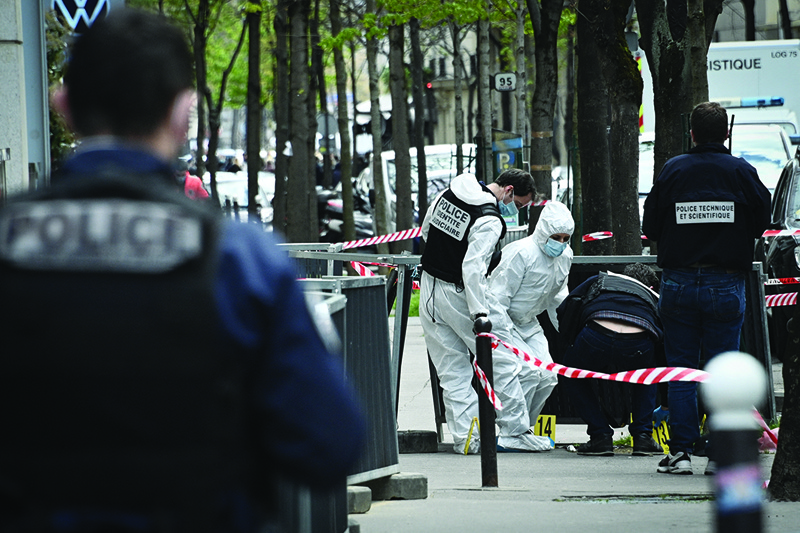 PARIS: French police forensic investigators search for evidence near the Henry Dunant private hospital where one person was shot dead and one injured in a shooting.-AFPn