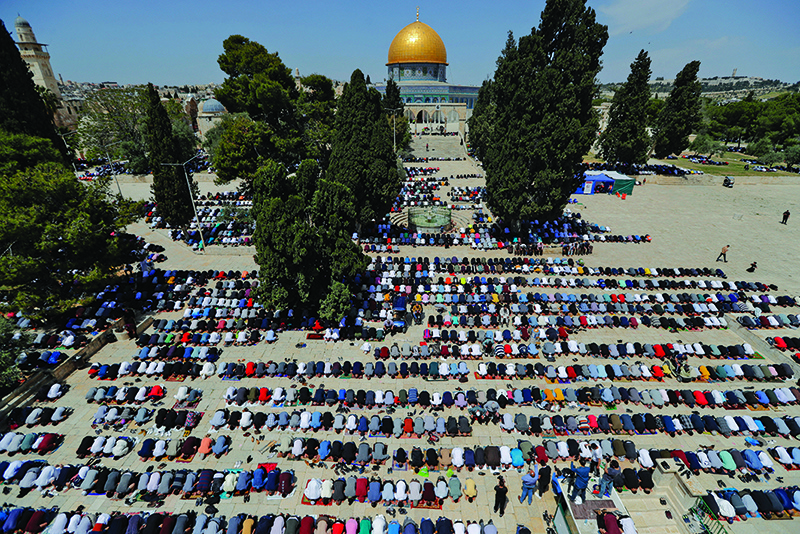 Palestinians take part in the first Friday prayers of the Muslim fasting month of Ramadan, at the Al-Aqsa Mosque compound, Islam’s third holiest site, in Jerusalem’s Old City, Friday. — AFP