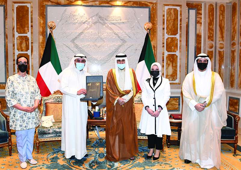KUWAIT: His Highness the Amir Sheikh Nawaf Al-Ahmad Al-Jaber Al-Sabah receives a copy of the national strategy for voluntary work. - Amiri Diwan and KUNA photosn