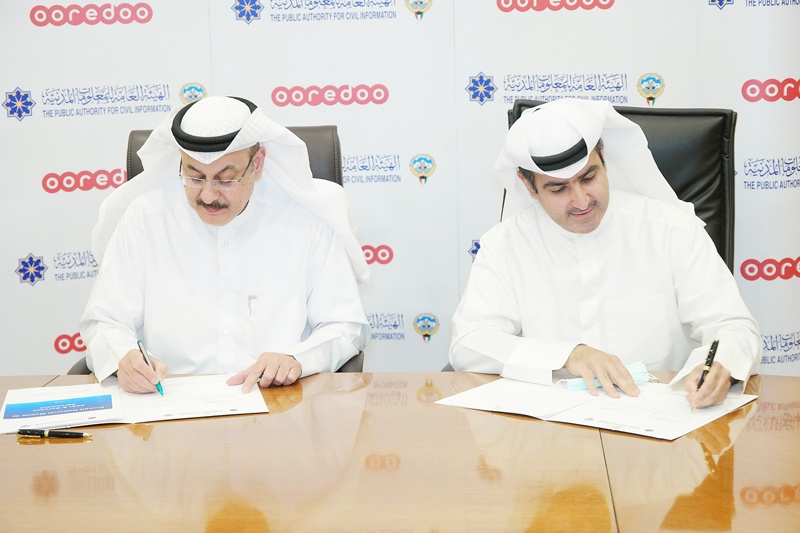 KUWAIT: Director General of Public Authority for Civil Information Musaed Al-Asousi (left) and CEO of Ooredoo Kuwait Abdulaziz Yaqoub Al-Babtain sign the agreement.nn